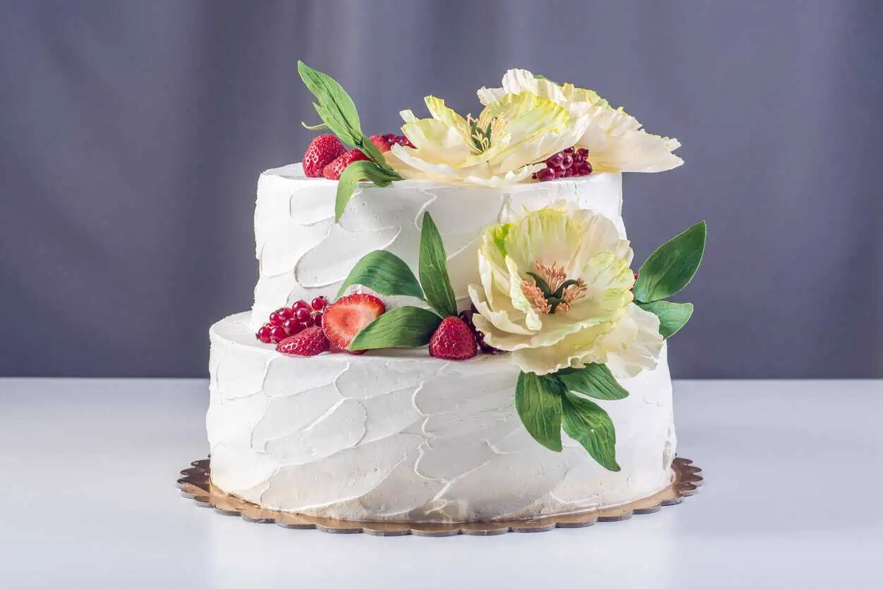 two tier wedding cake with cherries and berries