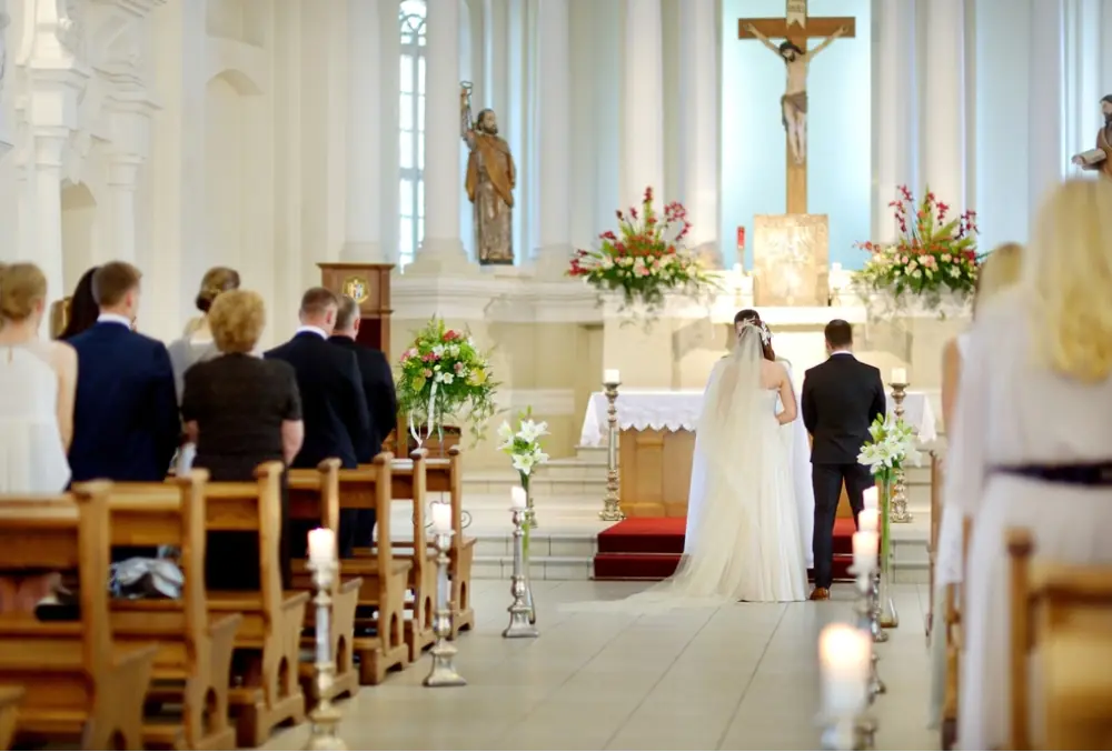 a couple tying the knot in a catholic church