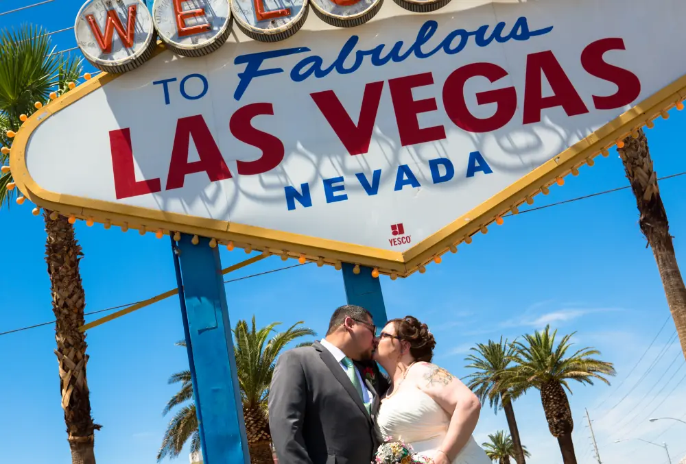 a newly wed couple at Las Vegas city banner