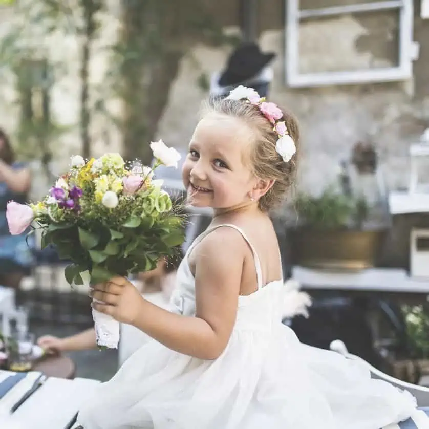flower girl holding flowers at a wedding
