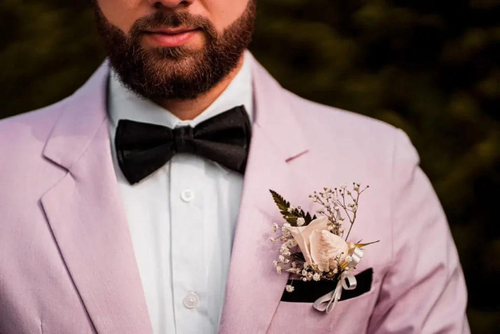groom wearing a boutonniere on his suit lapel