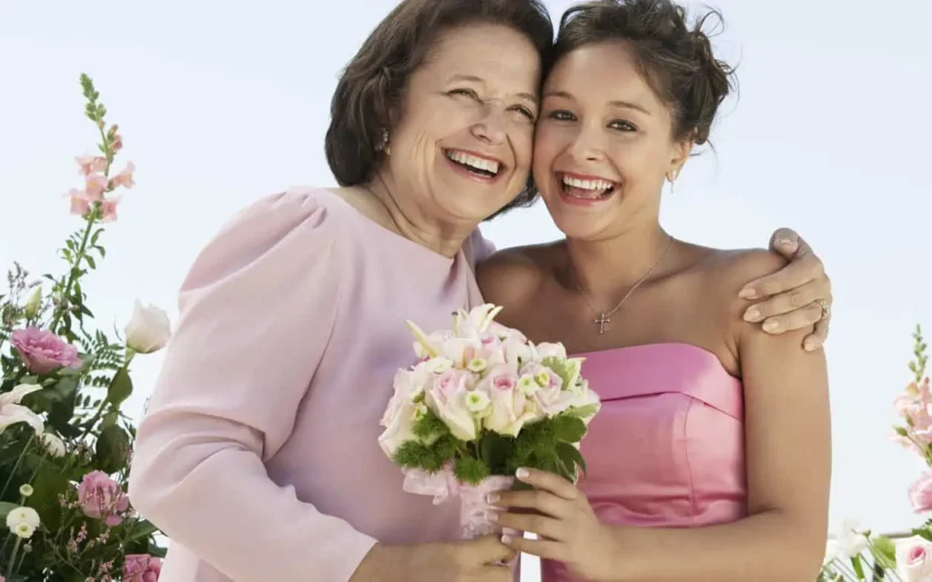mother of the bride holding flowers at her daughter's birthday